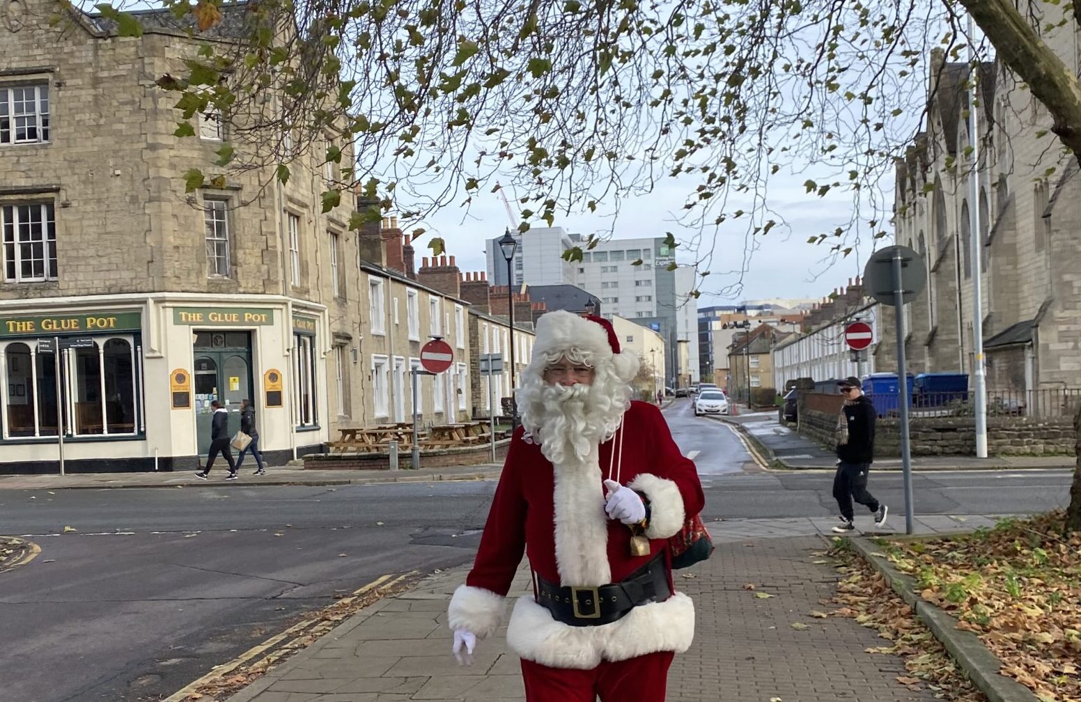 Santa walks through the Railway Village with the Gluepot Ale house in the background