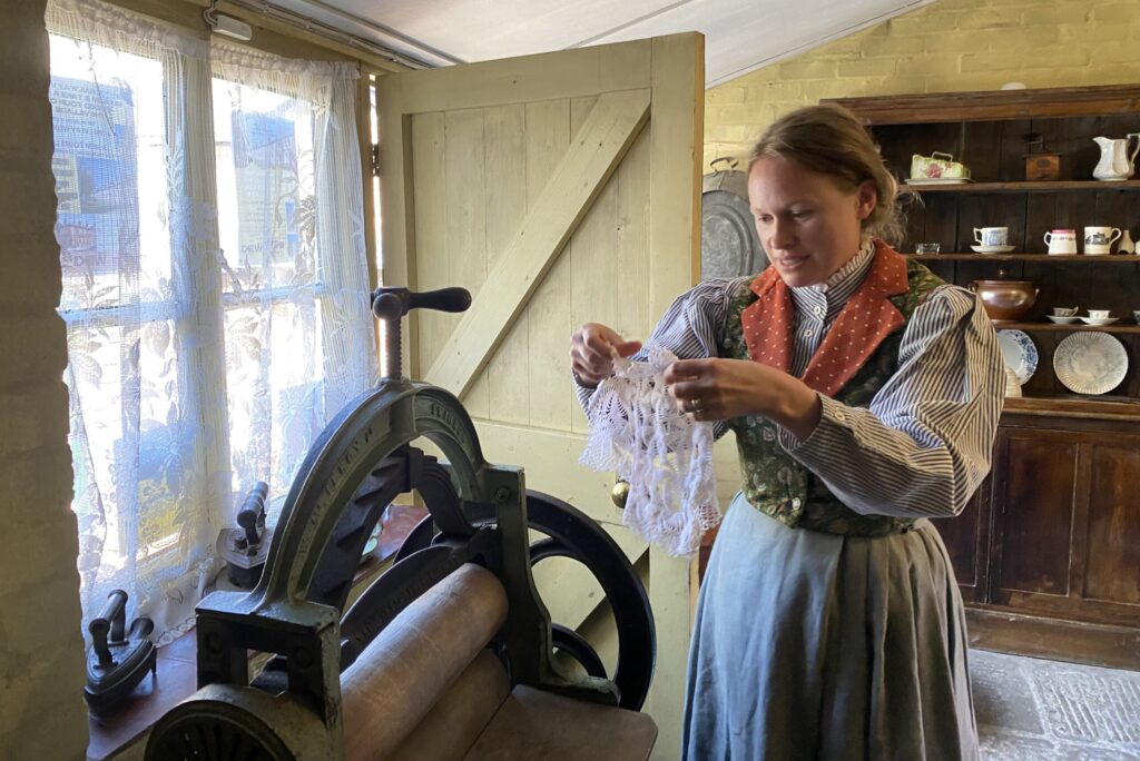 Mrs Smith holds a wet piece of cloth, trying to remove a stain.