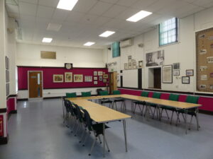 Picture inside the Central Community Centre's Main Hall with U-shaped tables and chairs.