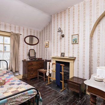 A Victorian bedroom with period furniture.